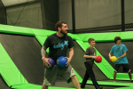 Three Men Holding Dodgeballs in Trampoline Ball Game